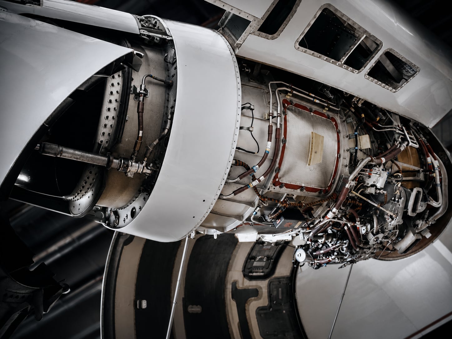 Close-up of a business jet engine with cowling open during inspection